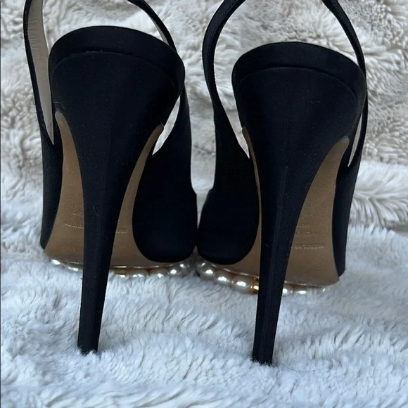 Nicholas Kirkwood black sling-back heals with signature pearl platform.